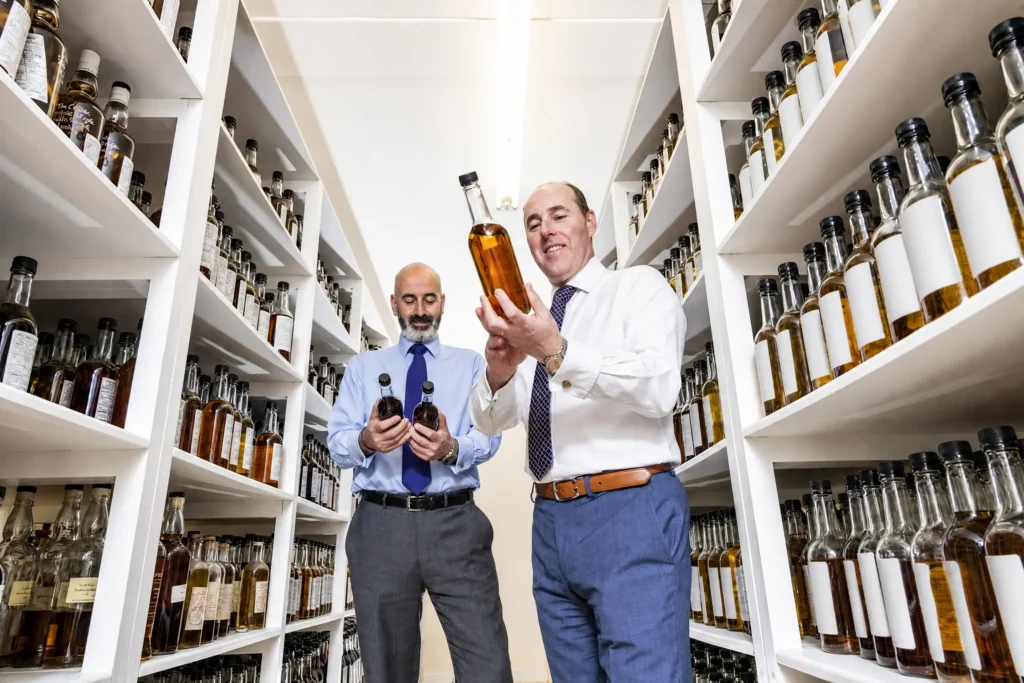 Two men testing bottles